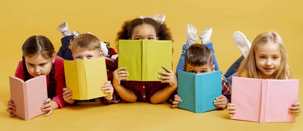 group-of-childrens-covering-their-faces-with-books